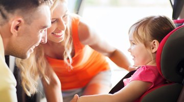 Girl sitting with her mother in a car