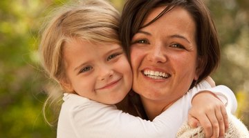 Hispanic mother hugging baby