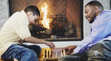 Father and son playing in front of fire