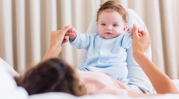 Mid adult man feeding a baby girl with a feeding bottle