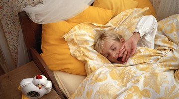 Cheerful girl sleeping with her teddy bear