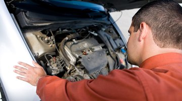 Man looking at car engine