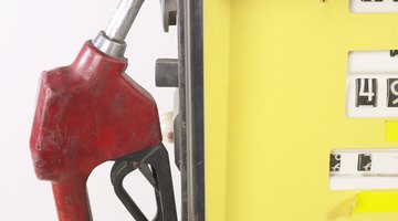 Woman putting gas in the tank of her car, extreme close-up