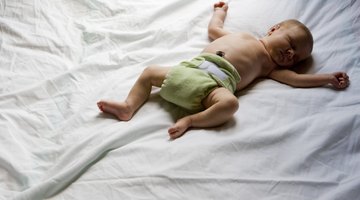 Newborn baby boy in hospital cot