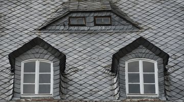 A rooftop with slate shingles on a historic home.