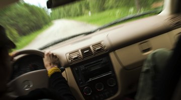 Silhouette of man reclining on hood of truck