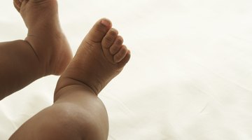 Baby girl (6-9 months) reaching upward, close-up