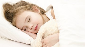 Baby sleeping on white bed
