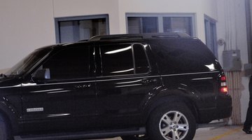 Silhouette of man reclining on hood of truck