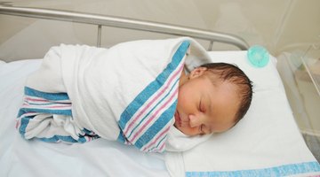 Baby girl (3-6 months) lying on blanket