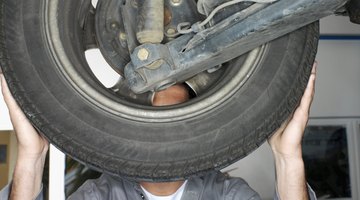 Mechanic tightening lug nuts on car tire