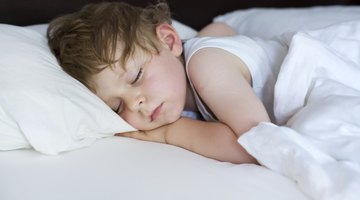 Baby sleeping peacefully in a white bed