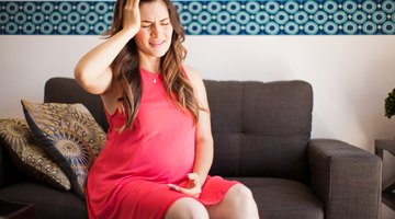 Pregnant Asian couple hugging