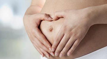 Pregnant woman holding belly in pharmacy
