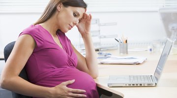 Pregnant woman holding belly in pharmacy