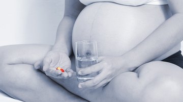 Close up image of woman drinking round white pill