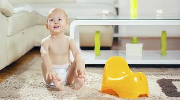 Toddler in bathroom look at the toilet