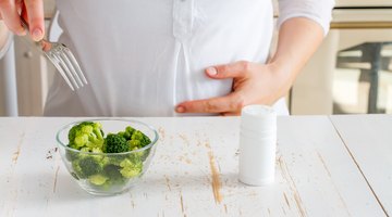 Pregnant woman eating vegetables