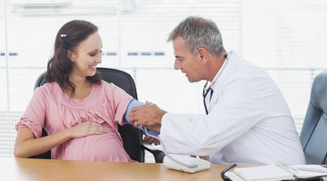 Doctor Taking Pregnant Womans Pulse