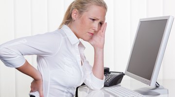 Young businesswoman having back and stomach pain