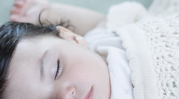 Baby sleeping on white bed