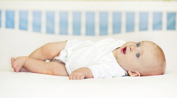 high angle view of a baby boy sleeping in a crib