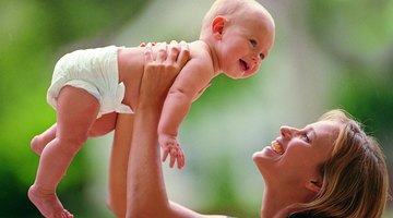 Smiling pregnant couple lying together in bed