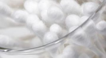 A cotton swab directs the solution to the stain.