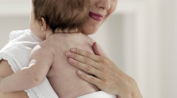 Mother holding baby boy on her shoulder