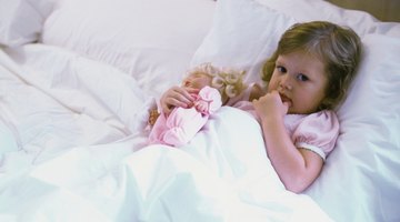 Mother reading bedtime story to daughter