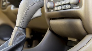 Woman sitting in car, rear view, mid section