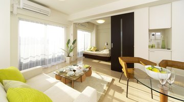 A white living room and dining area with lime green accents.