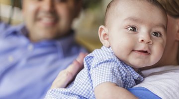 Close up of newborn baby in mother's arms