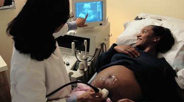 Husband and pregnant wife in hospital with doctor