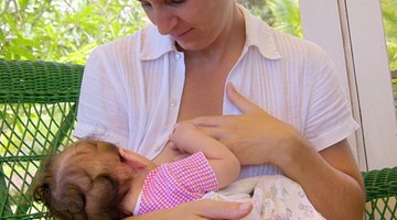 Mother breast feeding baby girl