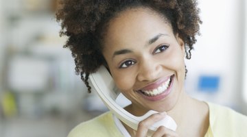 Smiling teenage girl using cell phone