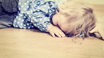 Little kid boy crying at home and showing sad mood