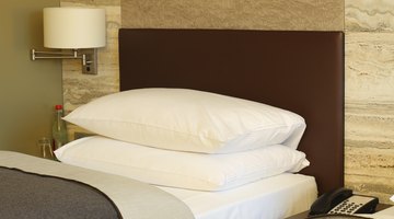 Pillows laying flat on hotel bed