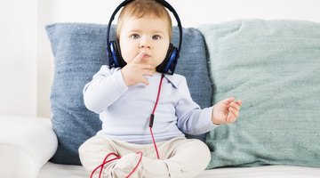 Expectant mother with headphones on her belly