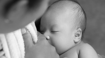 Close up of newborn baby in mother's arms