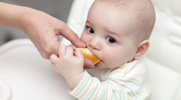 Asian baby boy eating blend food on a high chair