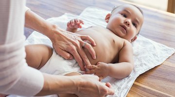 Mother with baby on changing table