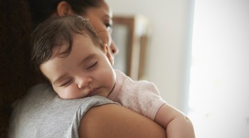 Portrait of a baby in baptismal clothing