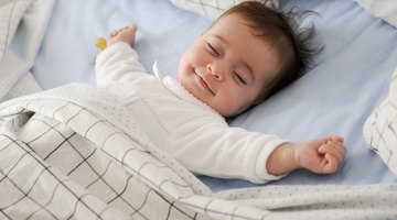 Sleeping Newborn Infant in Hospital Bassinet