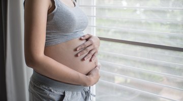 Pregnant woman with her husband and son