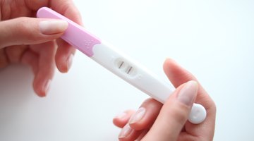 low angle view of a couple looking at a pregnancy test in the bathroom