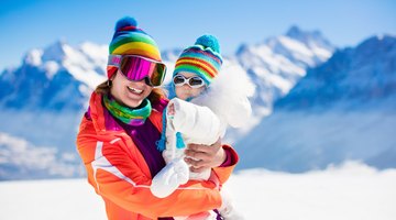 Portrait of a Mother and Her toddler in Woollen Hats in the Snow