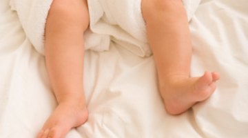 Newborn baby lying on a white background