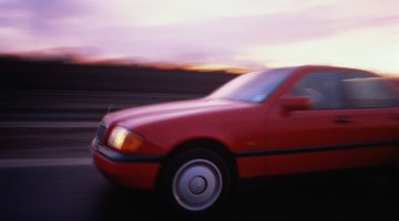 Silhouette of man reclining on hood of truck