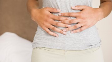 woman lying in bed with flu and fever feeling sick